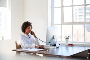 Young business woman uses VoIP.